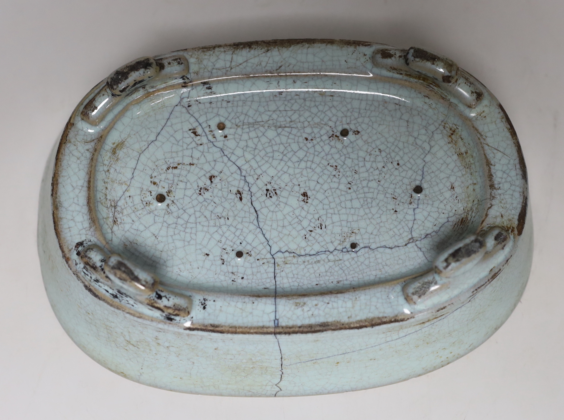 A Chinese celadon crackle glazed oval dish, 23cm wide